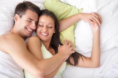 Happy guy and girl in bed